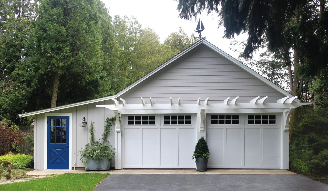 Clopay Grand Harbor doors on a gray carriage house