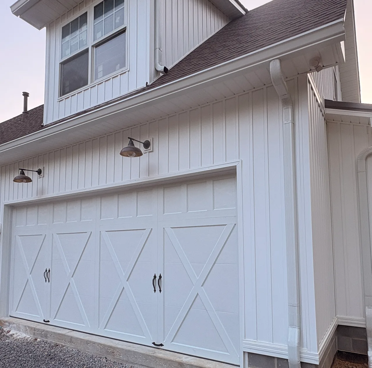 White cross-buck doors on a board-and-batten house