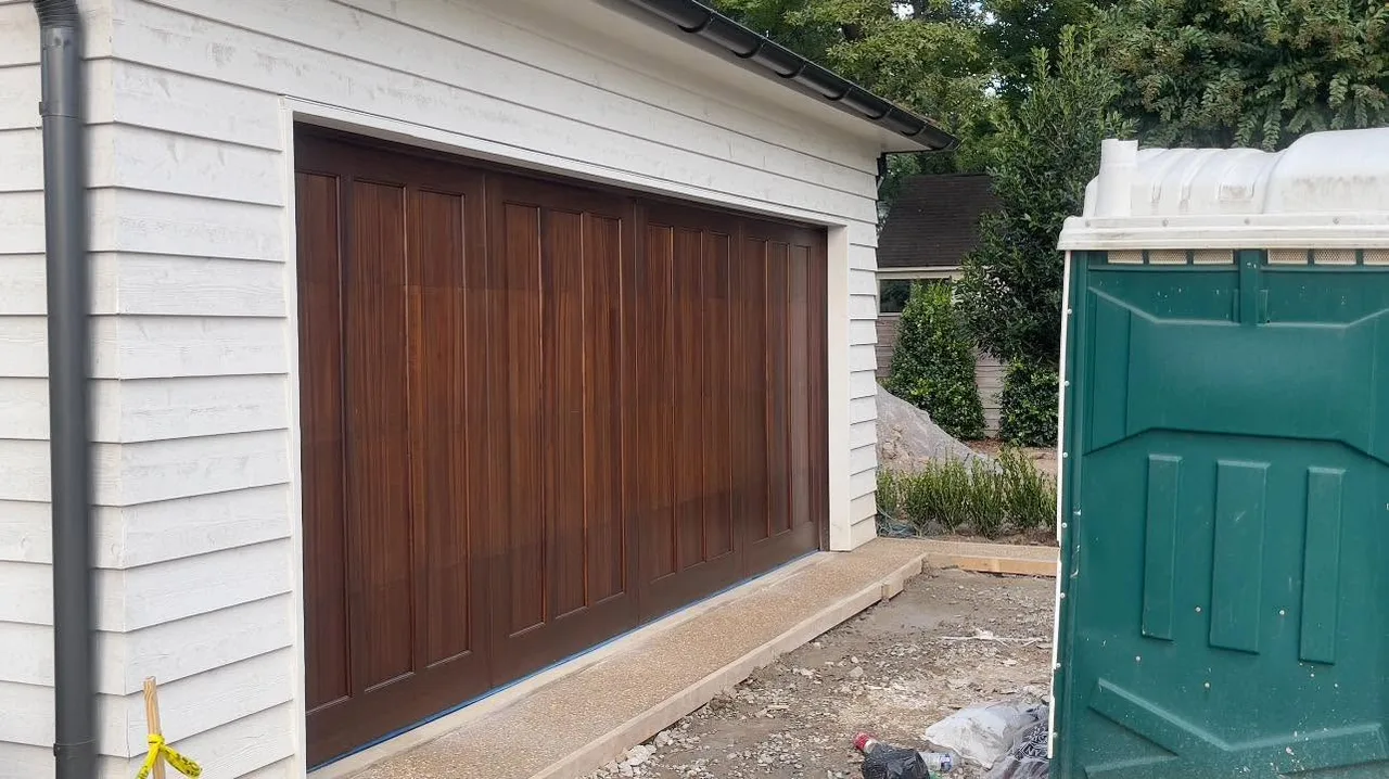 A wood-look door on a white garage